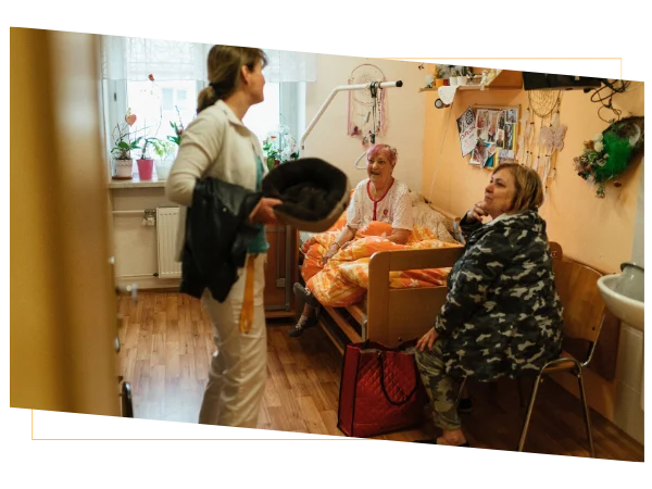 Older women talking in a bedroom while discussing health insurance tips Older women talking in a bedroom while discussing health insurance tips
